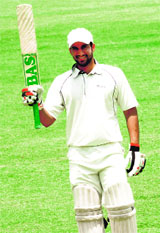 Amit Prashar of Stadium XI waves his bat after scoring a century against the Warrior Cricket Club at the cricket stadium in Sector 16, Chandigarh, on Sunday.