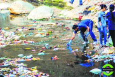 Volunteers of MAD clean the Tamsa stream near Tapkeshwar temple in Dehradun on Sunday. 