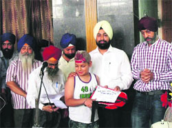 Winners of the religious contest are felicitated by the Sri Guru Singh Sabha in Dehradun on Sunday. 