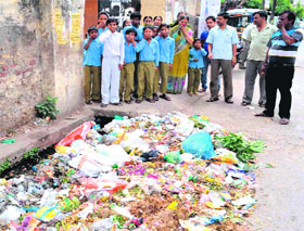 Heaps of garbage at the entrance of the Shastri Primary School, Jwalapur in Haridwar, pose problems for children.