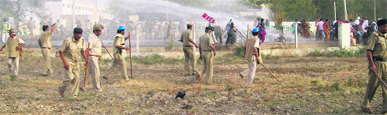 Policemen chase away protesters in Kaithal on Sunday.