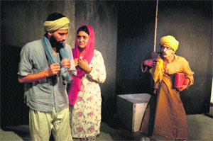 Artistes enact a play Gareeb Log, directed by Neeraj Kant, in Natrang Sunday Theatre Series. 