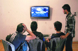 Youths engage in e-gaming in Srinagar on Sunday. 