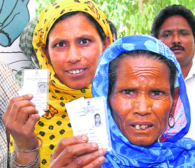 Migrant women queue to cast their vote at Mundh village in Jalandhar on Sunday.