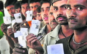 Voters queue up at a polling booth at Gill village in Ludhiana district on Sunday.
