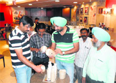 District Health Officer Dr Shivkaran Singh Kahlon and his team collect samples from a food joint at Celebration Mall in Amritsar on Monday.