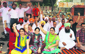 Congress municipal councillors stage a protest against the non-functional lifts in the newly constructed MC office in Jalandhar on Monday. 