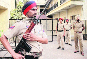 Policemen stand guard outside the strong room on the eve of the counting of votes for the Zila Parishad and Block Samiti polls in Jalandhar on Monday. 