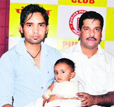 Dr Pawan Suri (right) with the 14-month-old child in Jalandhar on Monday. 