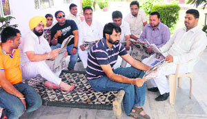 A zila parishad election candidate and his supporters relax in Dehlon on Monday.