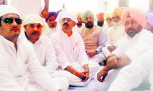PPCC chief Partap Singh Bajwa with other party leaders at the bhog ceremony of Sukhraj Singh at Bhagupur village in Patti on Monday.