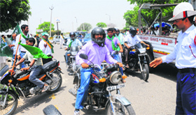 A policeman diverts the traffic from the main road