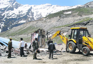 Forest Department officials demolish illegal structures at Marhi on way to the Rohtang Pass on Tuesday. 