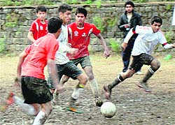 Players in action during a We and Football tournament at Dharamsala