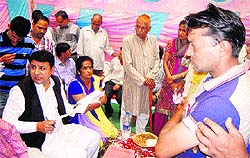 Minister for Housing and Urban Development Sudhir Sharma listens to the grievances of people at Passu village