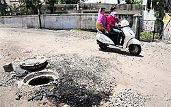 Open manholes dot the road to the Yatri Niwas from where devotees begin the Amarnath Yatra, in Jammu