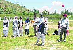 Girls participate in an event at the Baramulla Annual Athletic Meet in Janbazpora on Tuesday
