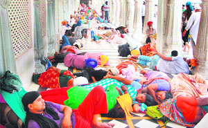 Devotees rest at a corridor of the Golden Temple in Amritsar on Wednesday. 