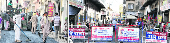 Work in progress at ward No. 22 and 36; and (below) barricades are placed to block the traffic where the roads were being laid in Bathinda on Wednesday. 
