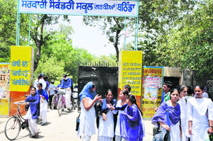 Students come out from a school in the afternoon in Bathinda on Wednesday. 