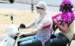 Girls protect themselves from the sun in Chandigarh on Wednesday