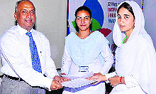 Dr Arun Kumar, director of Dolphin Institute, Dehradun, honours the winners of a competiton at the institute on Wednesday