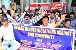 Kashmiri pandits protest against the government for violation of their human rights, outside the press club, in Jammu on Wednesday. Tribune photo: Inderjeet Singh 