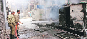 Firemen douse the fire that broke out in a generator set on the Mall Road in Ludhiana on Wednesday. 