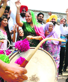 Party supporters dance to the beat of the dhol in Patiala on Wednesday. 