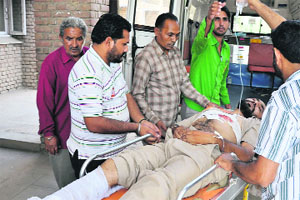An injured security guard being taken to hospital in Gidderbaha on Wednesday. 