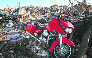 A Harley Davidson motorcycle that was salvaged from the rubble after a powerful tornado ripped through Oklahoma on Tuesday. The town reported a tornado at least 2 miles wide and killed 24 persons.  AFP