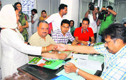 Officials distribute party symbols at Mini-Secretariat in Panchkula on Thursday. 