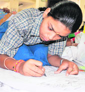 A girl participates in a poster-making competition organised by the Pollution Control Research Institute at BHEL in Haridwar on Thursday.