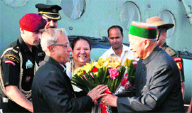 President Pranab Mukherjee being welcomed by Chief Minister Virbhadra Singh as Governor Urmila Singh looks on at the Kalyani helipad in Shimla on Thursday.