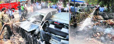 Firemen douse flames in the cars that were gutted due  to the burning of garbage in Jalandhar on Thursday; and (right) the burning garbage mounds near the Jalandhar bus stand. 