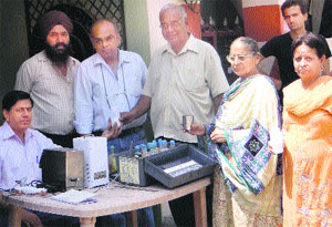 Residents of Shaheed Bhagat Singh Colony get a sample of milk tested at a free milk testing camp organised by officials of Verka Milk Plant in Jalandhar on Thursday. 