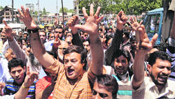 Members of the Jammu and Kashmir Teachers Forum raise slogans during a protest in Srinagar on Thursday.
