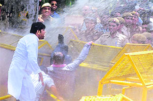 Policemen use water cannons on Bharatiya Janata Yuva Morcha workers during a protest against alleged corruption by the UPA government in New Delhi on Thursday.
