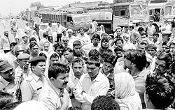 Policemen try to pacify residents of Kurar and Budsham villages blocking Gohana road on Friday in support of their demand for a search operation to locate the bodies of Joginder, his daughters, son and wife, who allegedly jumped into the Western Yamuna Canal in Panipat on Thursday