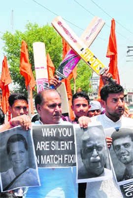 Workers of the Dogra Front and Shiv Sena protest against the cricket match fixing issue in Jammu on Friday.