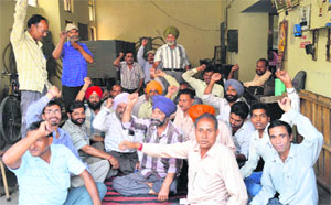 PSPCL employees stage a protest in Ludhiana on Friday.