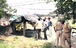 MC officials clear an encroachment from Tajpur Road in Ludhiana on Friday.