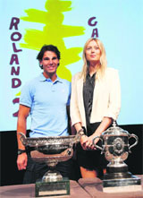 Defending champions Rafael Nadal and Maria Sharapova at the draw for the French Open in Paris on Friday, while strong contender Serena Williams (below) practises two days before the event starts.