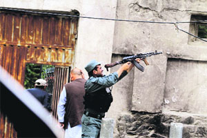 An Afghan policeman in action during a gunbattle following a suicide attack in Kabul on Friday.