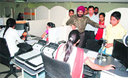 Passport Officer JS Sodhi intracts with an applicant at the passport mela in Amritsar on Saturday.