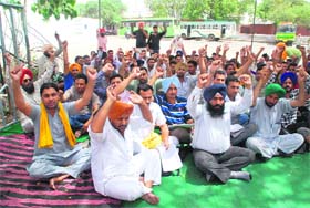 UP IN ARMS: Members of the Contract PRTC Workers Union (azad) protest in support of their demands outside the PRTC workshop in Bathinda on Saturday