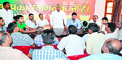 BJP state vice-president Madan Kaushik addresses party workers at the Devpura city party office in Hardiwar on Saturday