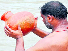 A devotee offers prayers at Brahma Kund, Har-ki-Pauri, on the occasion of Buddha Purnima in Haridwar on Saturday