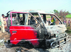 The charred wreckage of a school van on the outskirts of Gujrat city.