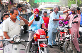 People drink sweet water at a stall (chabeel) in Bathinda on a hot Sunday afternoon.